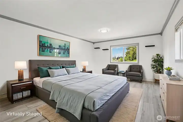 Spacious primary bedroom at 4612 N 21st St, Tacoma, WA — virtually staged to showcase its generous layout, wide-plank flooring, large windows with natural light, and flexible space for a sitting area or home office. This North Tacoma retreat offers comfort, privacy, and room to personalize with modern finishes throughout.