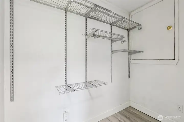Additional storage space at 4612 N 21st St, Tacoma, WA — featuring built-in wire shelving, durable flooring, and convenient access to the attic. This flexible North Tacoma storage area is perfect for seasonal items, organization needs, or expanding closet capacity in the home.