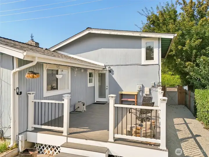 Cozy backyard deck at 4612 N 21st St, Tacoma, WA — featuring a spacious outdoor seating area, updated railing, string lighting, and easy access to the home and side yard. This North Tacoma outdoor retreat is perfect for entertaining, BBQs, relaxing, or enjoying sunny days in a private fenced setting. No HOA!