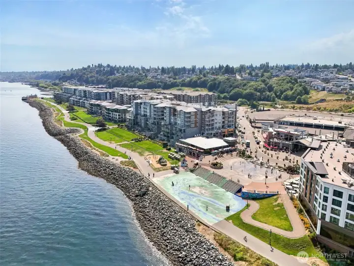 Aerial view of Point Ruston—Tacoma’s vibrant waterfront destination—featuring miles of scenic shoreline trails, dining, shopping, entertainment, and family-friendly recreation. Just a short drive from the home, offering easy access to some of the area’s most desirable amenities and Puget Sound views.