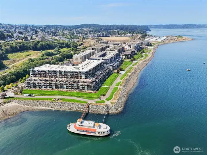 Aerial view of Point Ruston—Tacoma’s vibrant waterfront destination—featuring miles of scenic shoreline trails, dining, shopping, entertainment, and family-friendly recreation. Just a short drive from the home, offering easy access to some of the area’s most desirable amenities and Puget Sound views.