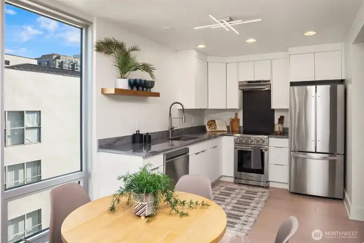 So much light in this corner unit! Floor to ceiling window in the kitchen/dining area