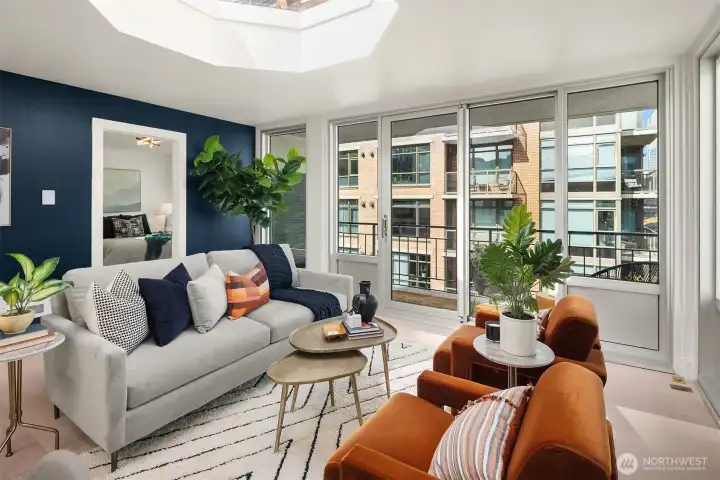 Spacious living room with multiple configuration options, looking toward primary bedroom suite