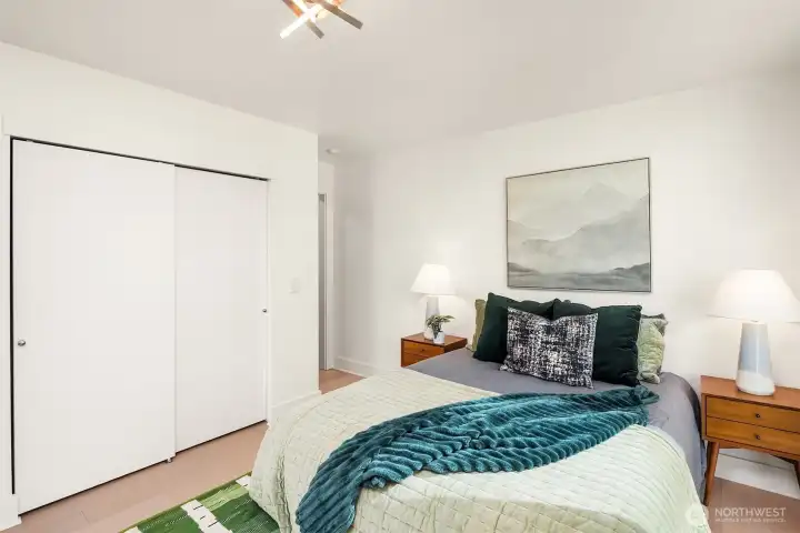 Primary bedroom has spacious double closet, looking toward ensuite bath