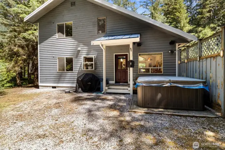 Backyard relaxation area featuring the private hot tub.