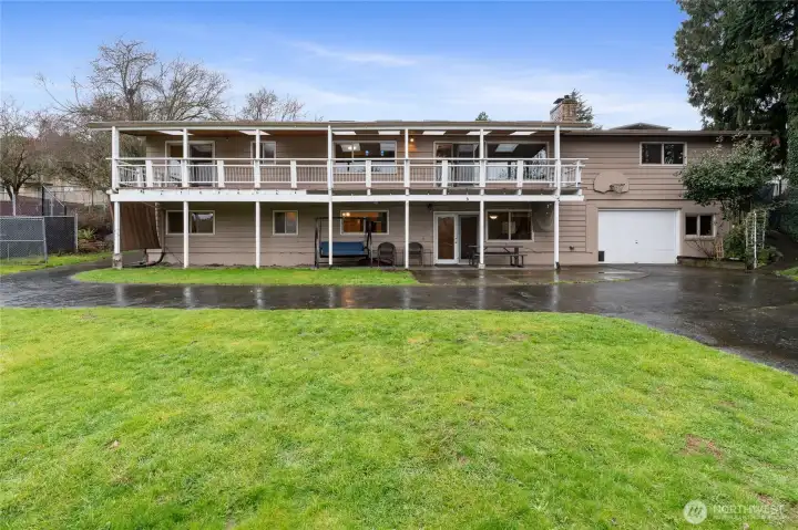 This is a view of the awesome covered deck, lower patio and 2 car garage for lower unit.