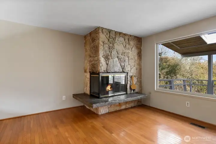 The fireplace is definitely the focal point of the living room. Notice the huge picture window!