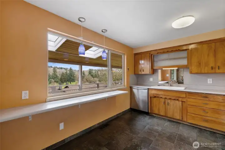 Upper kitchen with large windows looking out to the golf course.