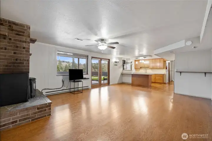 A view of downstairs living room looking into the kitchen.