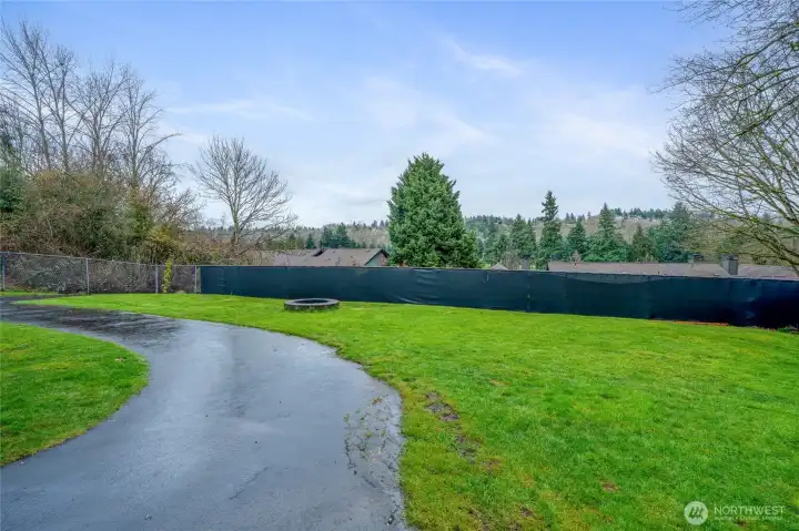 Fully fenced, level back yard offers plenty of room for garden beds, or additional landscaping. This also shows the driveway to the 2 car garage for lower unit.