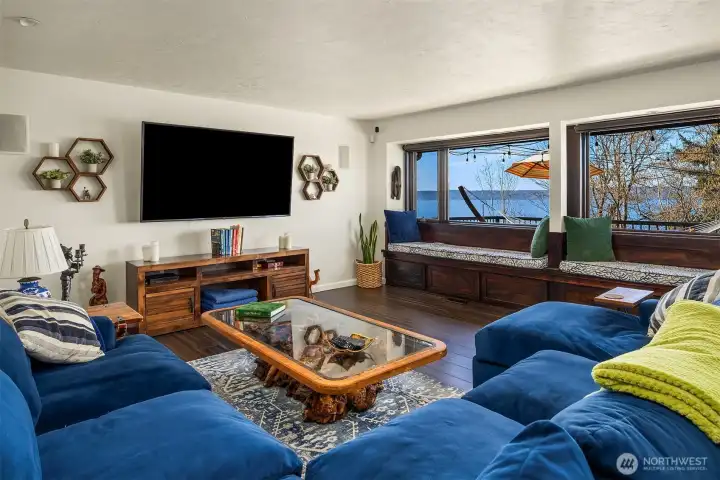 The main level features living and dining rooms, kitchen and primary suite. As you get comfortable in this spacious living room you can enjoy gorgeous views from two large picture windows overlooking the Sound.