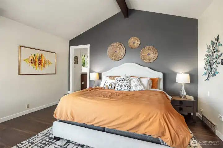 Light an airy primary suite has a tasteful accent wall, vaulted ceilings and unbeatable views.