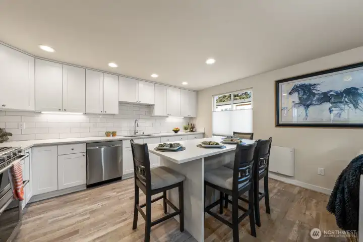 Kitchen with quartz counter top and ss appliances.