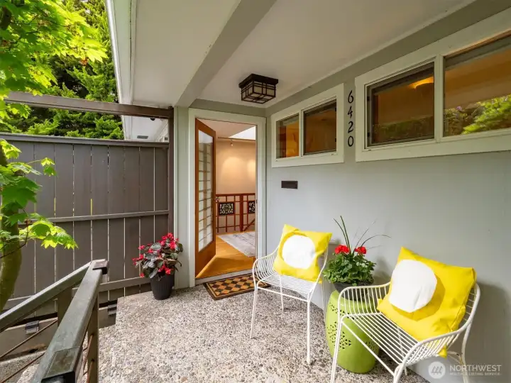 This home is framed by a canopy of trees and lush greenery.