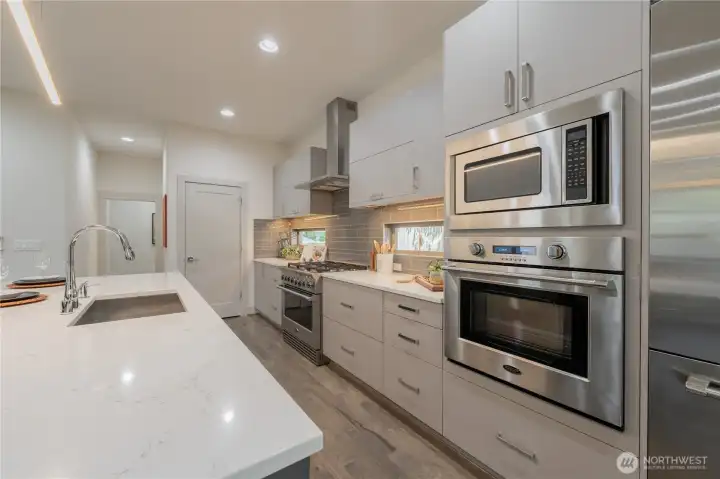 Extras include double oven, beverage refrigerator, under cabinet lighting and high-end cabinetry.
