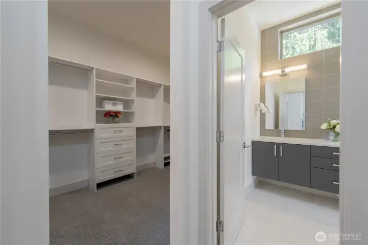 Huge walk in closet with built-in modular shelving.