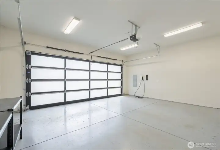 Large two-car garage with extra space for storage or shop. Don't miss the EV charger.