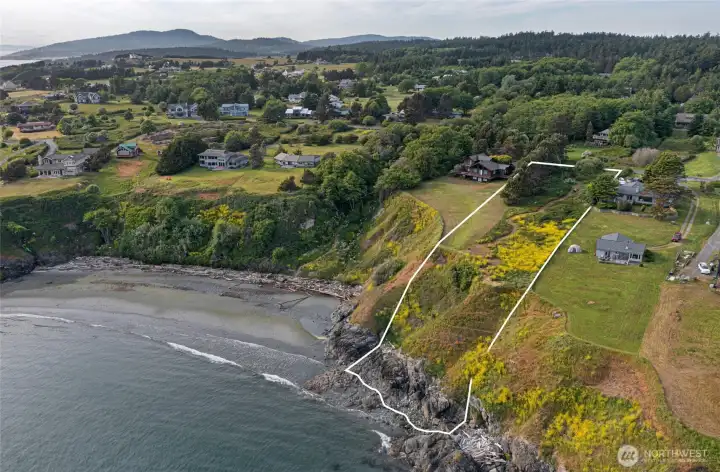 Wide shoreline perspective showcases the outlined parcel, nearby beach, and scenic waterfront setting ideal for a future island retreat.