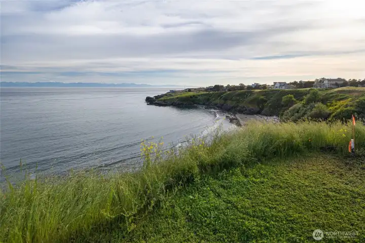 Scenic view from the property overlooks the nearby cove, shoreline, and surrounding San Juan Island waterfront homes.
