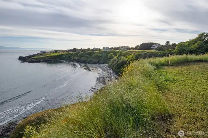 Coastal vantage point showcases the natural bluff, beach below, and wide-open sky, creating an exceptional setting for future island living.