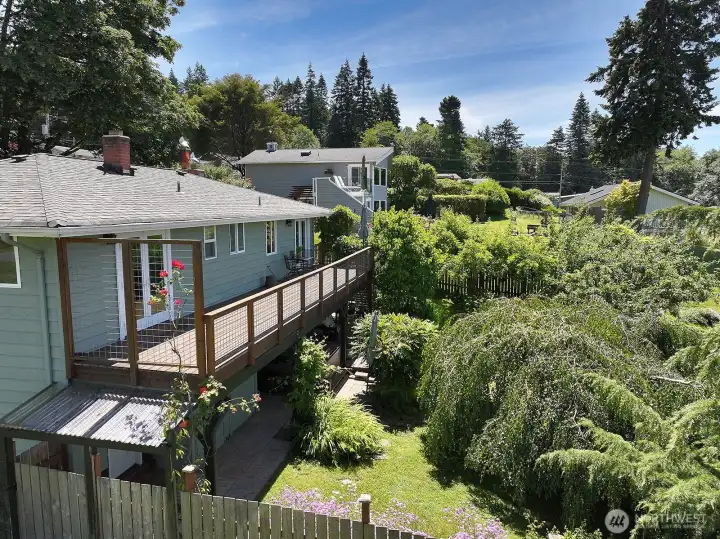 Here is another view of the deck and backyard. The exterior of the home is cedar that had a fresh new paint job in 2022.