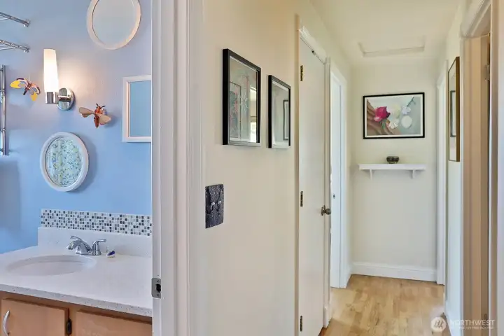 We are headed down the hall with the bathroom pictured on the left. The closed door on the left holds the stackable washer and dryer.
