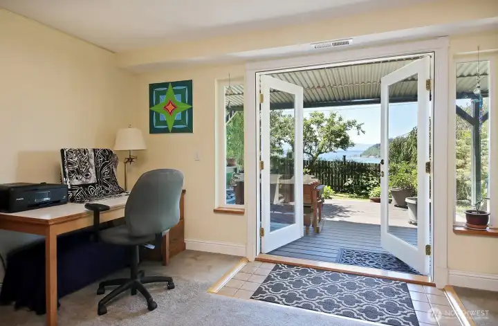 The french doors open to the lower deck and a nice covered seating area to soak in the views. The hot tub is to the right of the doors.