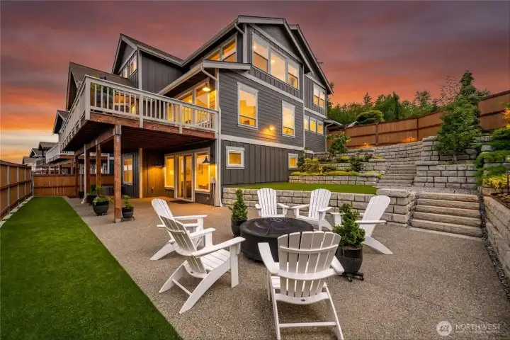 Turf grass frame this manicured backyard space with app controlled lighting and professionally designed landscaping Turf grass frame this manicured backyard space with app controlled lighting and professionally designed landscaping
