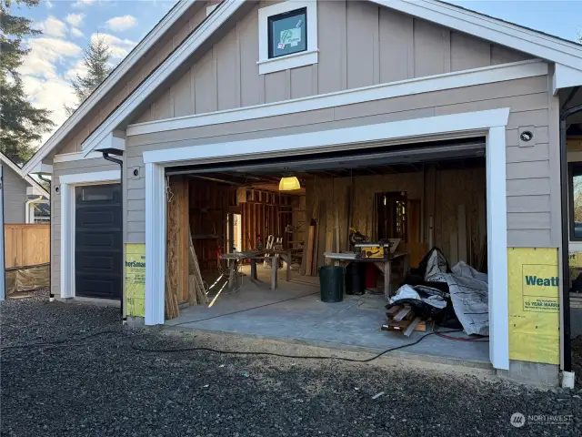 4 car garage with man door leading to paved walkway to back yard.