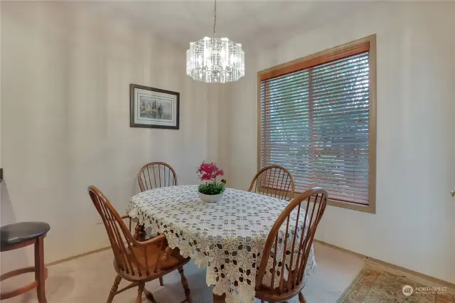 Dining area open to kitchen and to great room, and overlooking the peaceful, treed back yard.