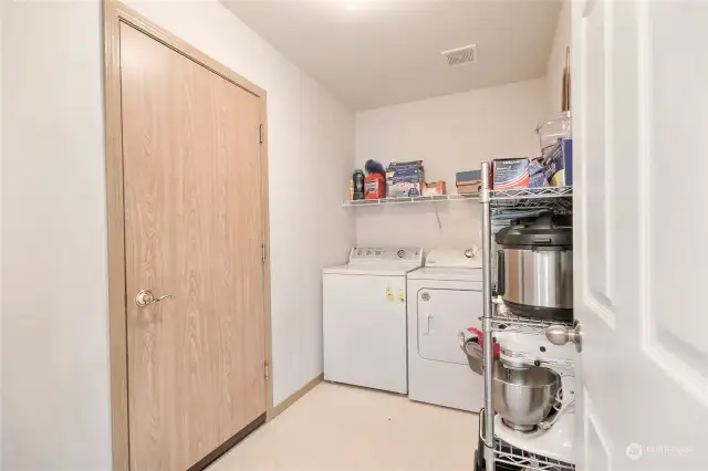 Big laundry room & washer & dryer stay. Door leads out to 3 car garage