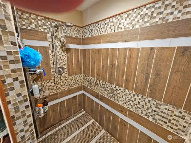 Deco tiled primary bedrm shower on the main floor.