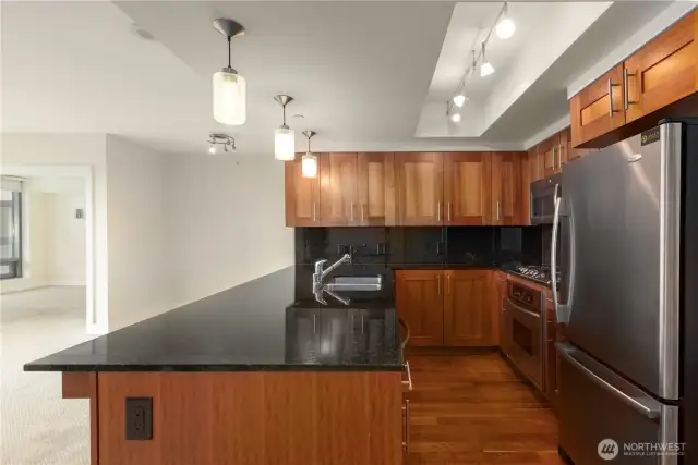 Lots of counter space and cabinetry with wide refrigerator with freezer drawer.