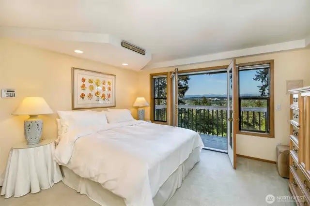 Upper level primary bedroom with private balcony.