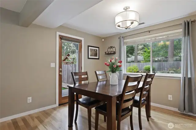 Dining nook windows overlook spacious backyard.