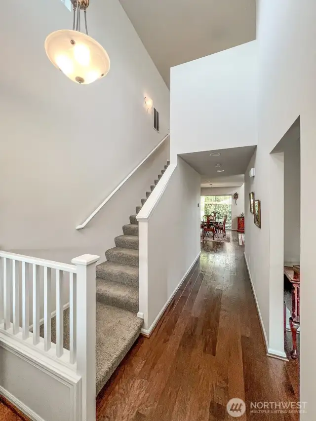Outside the primary suite is a wide, carpeted staircase that leads to a spacious, multi-functional loft, another full bath, and two more bedrooms.