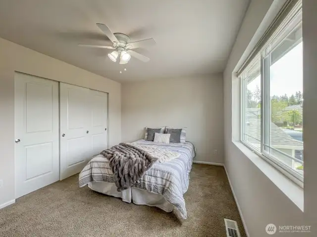 A light-filled, west facing upstairs bedroom with ample closet space - located near the top of the stairs and adjacent to the full bath.
