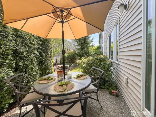 The outdoor patio- easily accessed through sliding doors from the great room- is a perfect and private spot for entertaining, reading, gardening, and sipping your coffee or enjoying an evening dinner outside. The mature hedge gives you privacy but still allows plenty of light. Don't forget there's space for grilling!