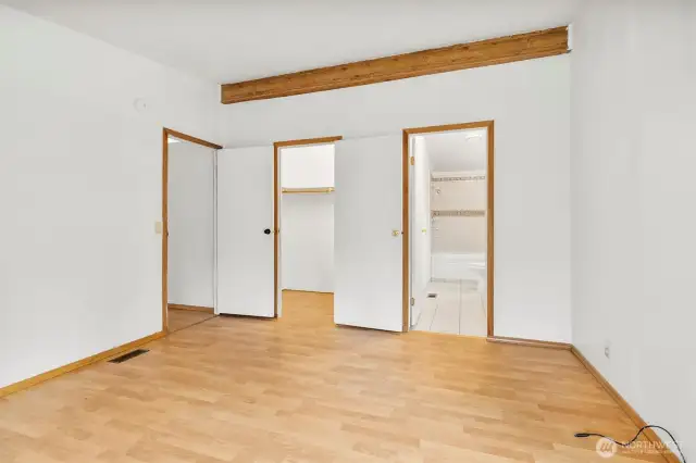 Large walk-in closet and full bathroom in primary bedroom