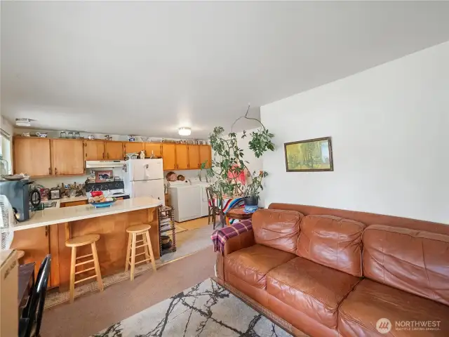 Living room/kitchen/washer and dryer in unit 2.