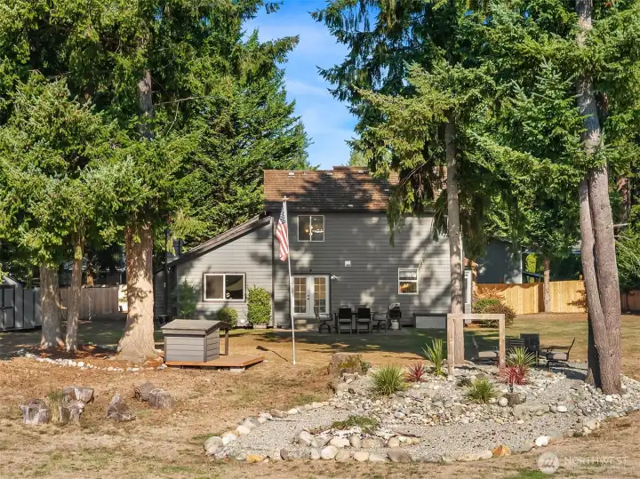 Water feature & rock garden with cozy fire pit.