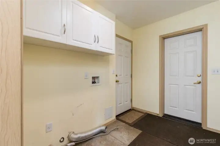 Laundry/mudroom between the kitchen and garage, with door to side yard. Includes gas dryer hookup!