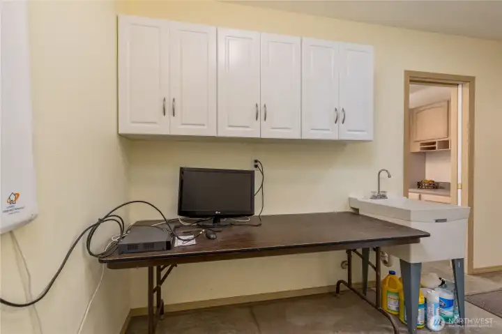 Laundry room includes utility room and cabinetry. Whold house surge protector!