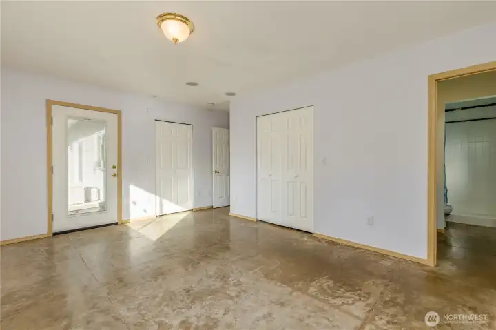 Large primary suite includes dual closets and direct access to the back patio and hot tub