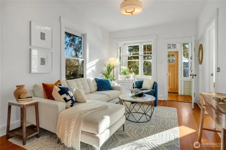 the gorgeous fir floors carry into the sunlit living and dining rooms