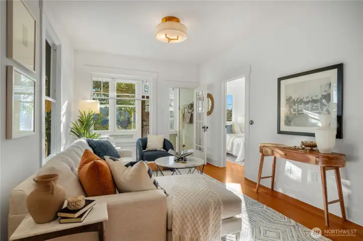 the gorgeous fir floors carry into the sunlit living room