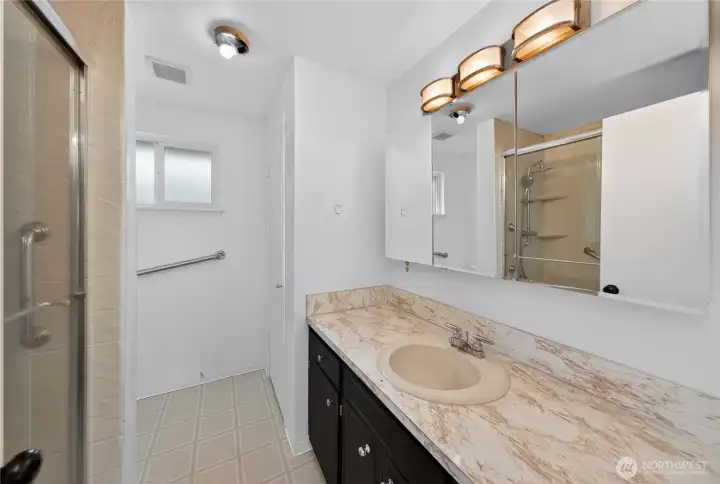 Spacious bathroom with ample counter space and storage for everyday convenience.