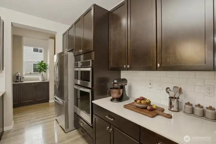 Kitchen has ample counter space AND there is a bonus butler's pantry AND walk-in pantry! (digitally staged)