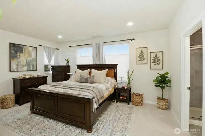 Primary suite with large bath ensuite, walk in closet. (some items digitally staged)