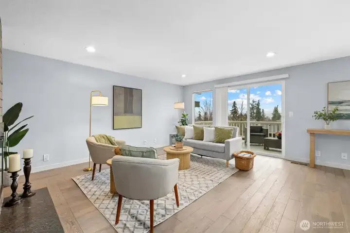 Light-filled living room with large picture window, territorial views, and warm natural light